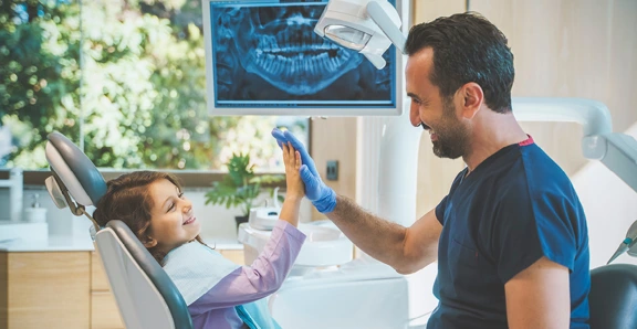 Dentist High Five Kid In Office