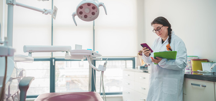 Dentist In Office On Smartphone