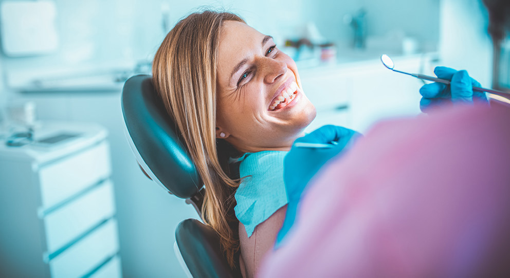 Patient At Dentist Office Smiling During Exam